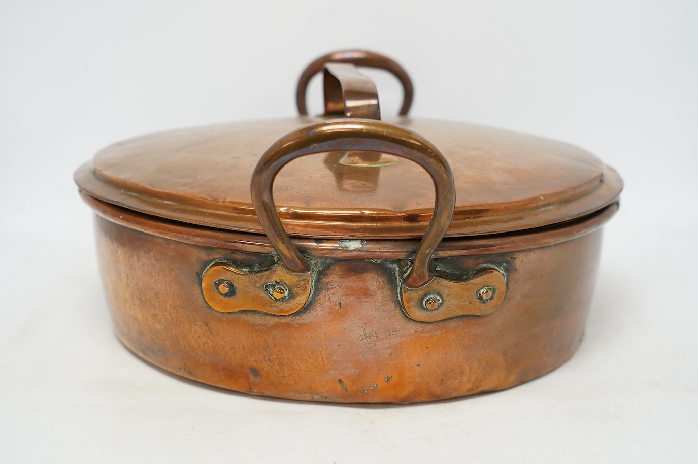 Two copper pans, one handled and the other with cover, 38cm diameter. Condition - fair